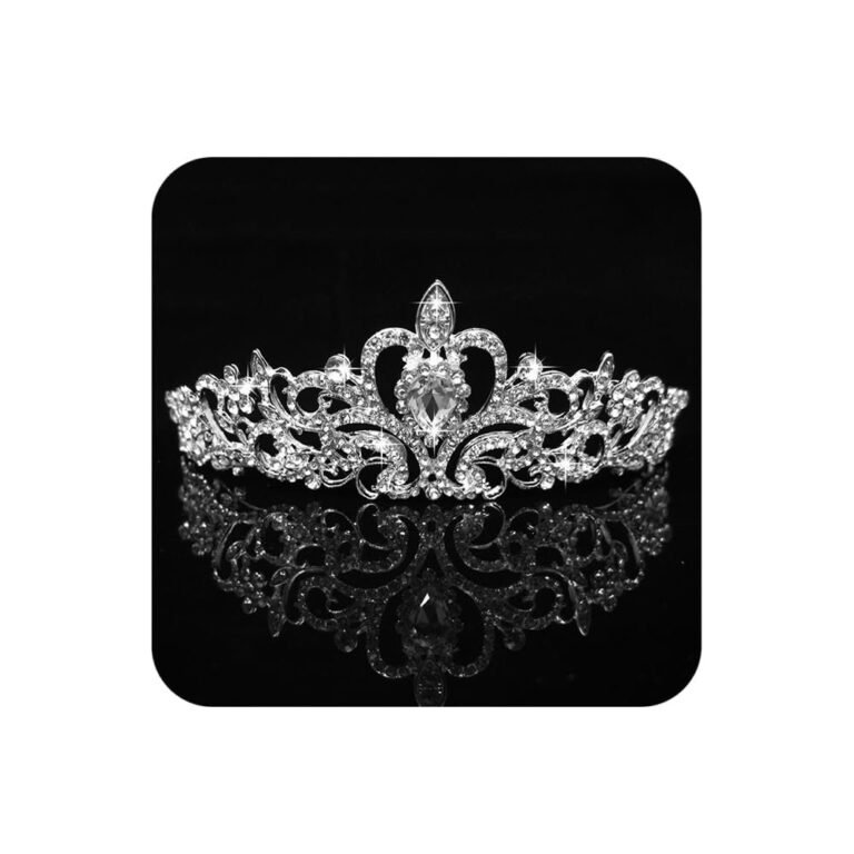 Silver tiara with clear crystals, reflecting on a black surface