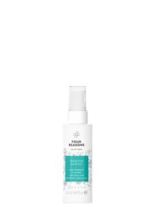 White bottle of "Four Reasons" sensitive hair oil with spray top
