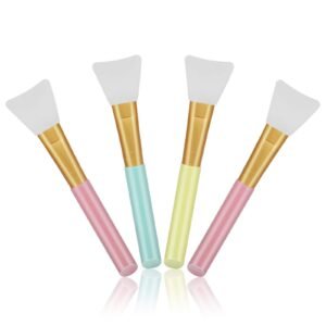 Four colorful cosmetic brushes with white spatula heads and gold accents