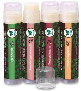 Four vegan lip balms in spearmint, strawberry, pomegranate, and peach apricot flavors