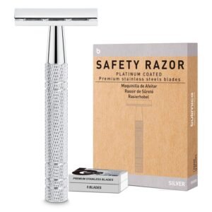 Silver safety razor, blade pack, and box with product information on white background
