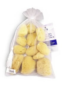 Bag of natural sea sponges with a tag, on white background