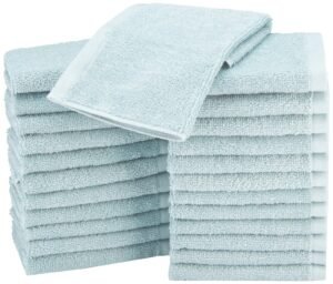 Stacks of light blue folded towels, with one towel on top