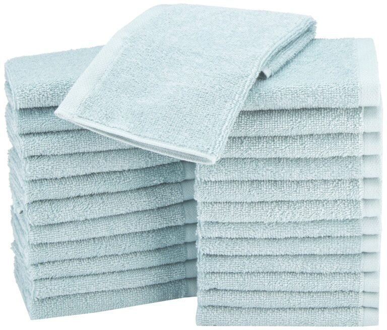 Stacks of light blue folded towels, with one towel on top